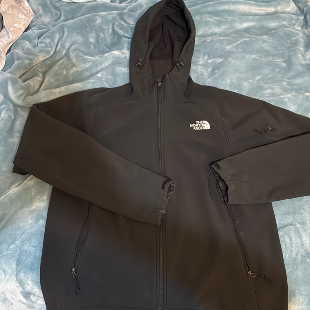 Great hooded North Face jacket in Medium. Has adjustable waist to tighten  Black